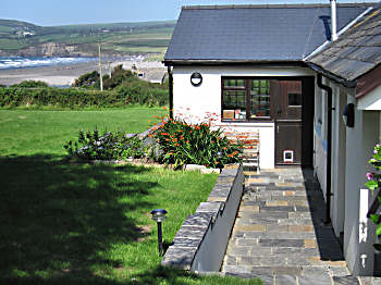 View of house, beach and sea in distance